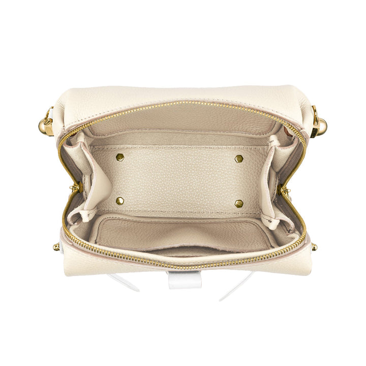 Beige leather handbag interior with zipper pockets and open compartments