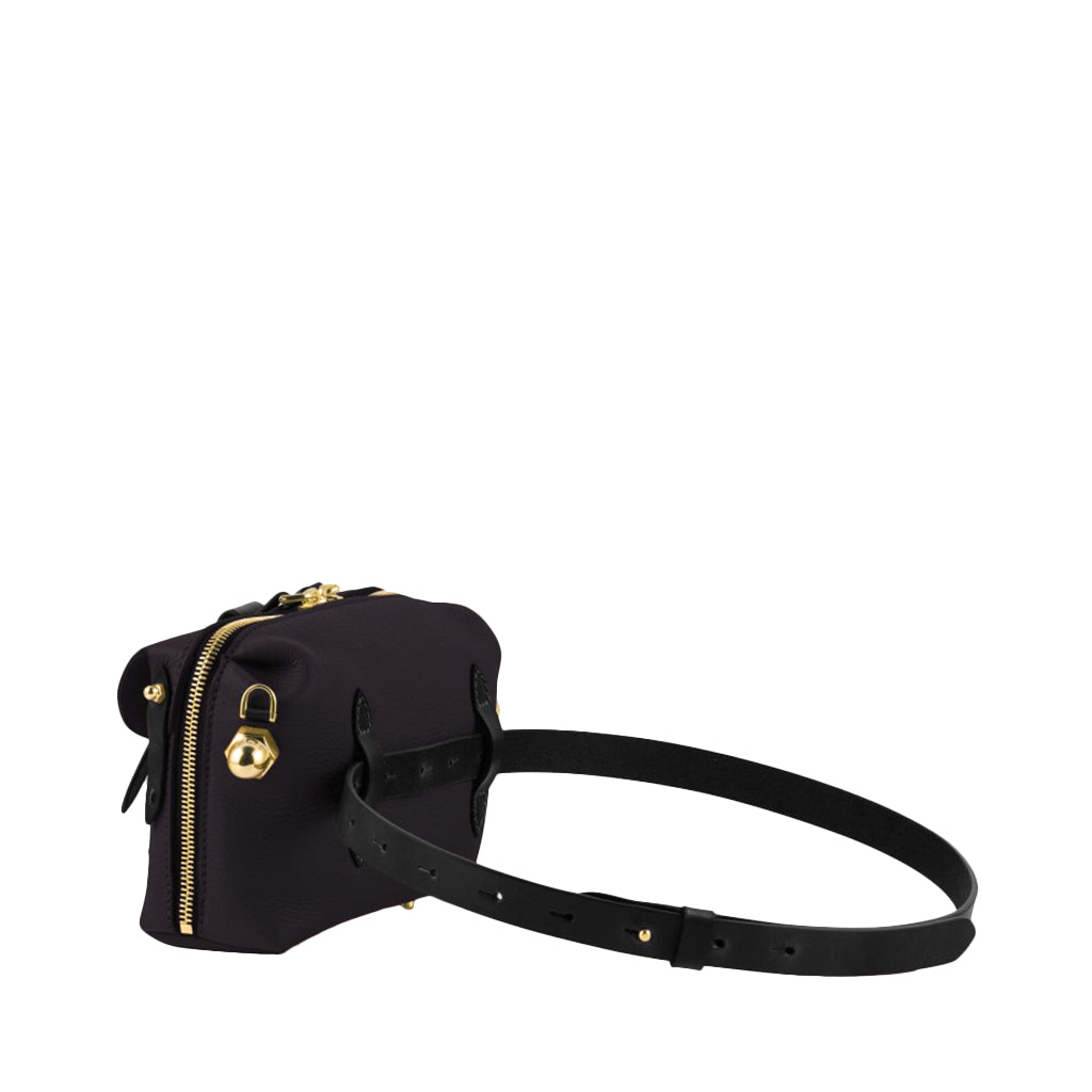 Black leather crossbody handbag with gold zipper and buckle detail