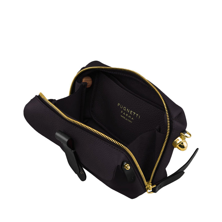 Open black leather handbag with gold zipper and brand name on the interior