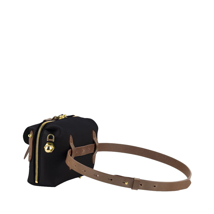 Black leather crossbody bag with tan adjustable strap and gold hardware