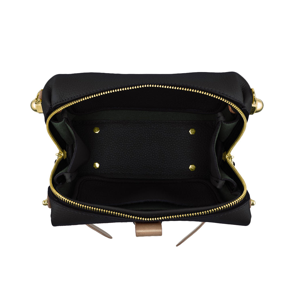 Top view of an open empty black leather handbag with gold zippers and hardware