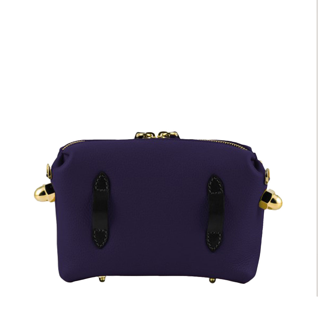 Purple leather handbag with gold accents and black straps