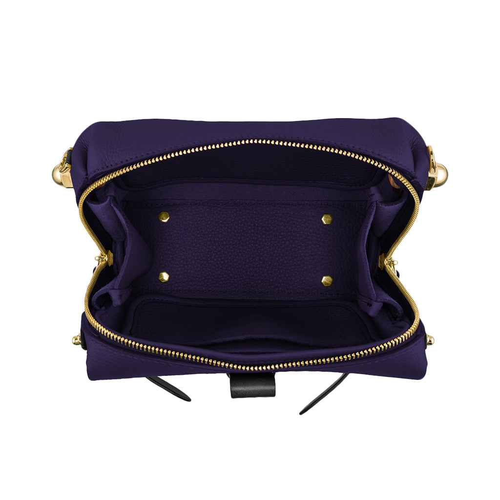 Open purple handbag with gold zippers and empty interior