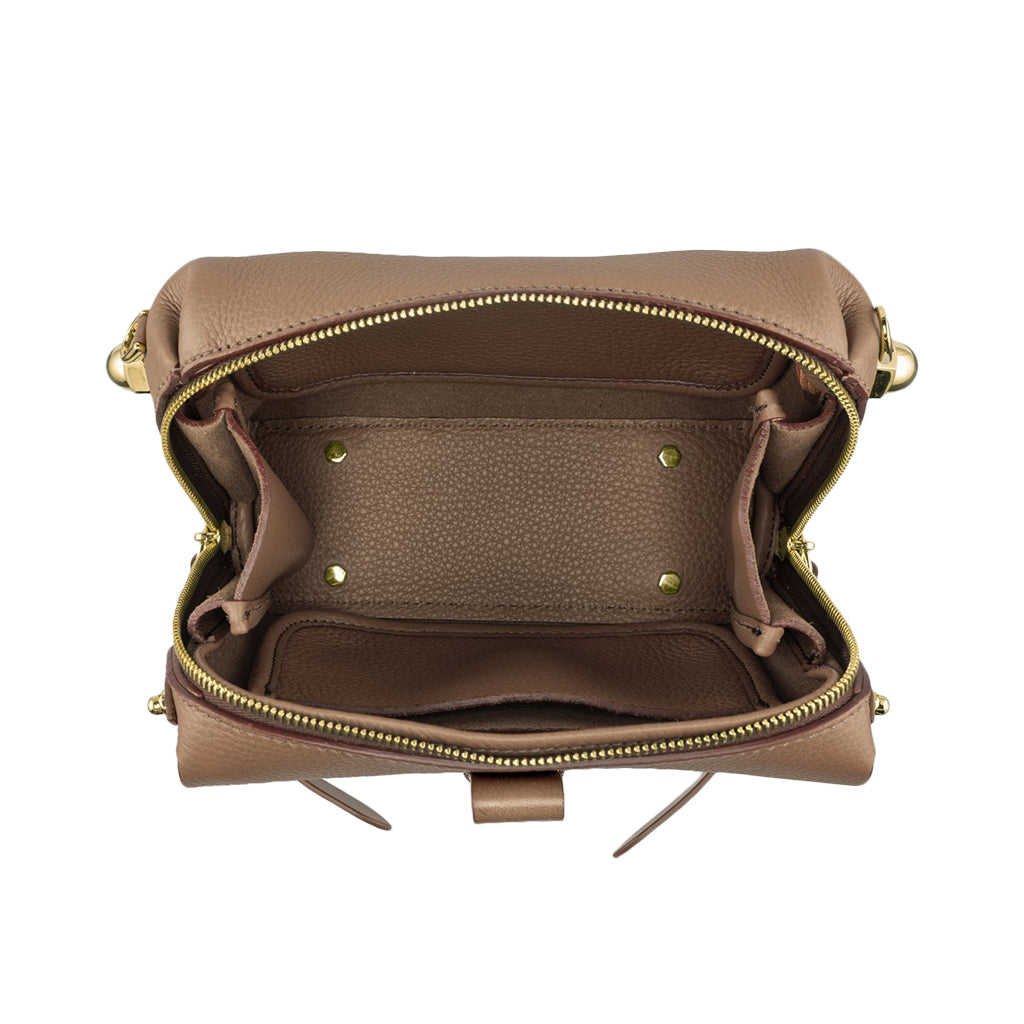 Open brown leather handbag showing empty interior with gold zipper and hardware