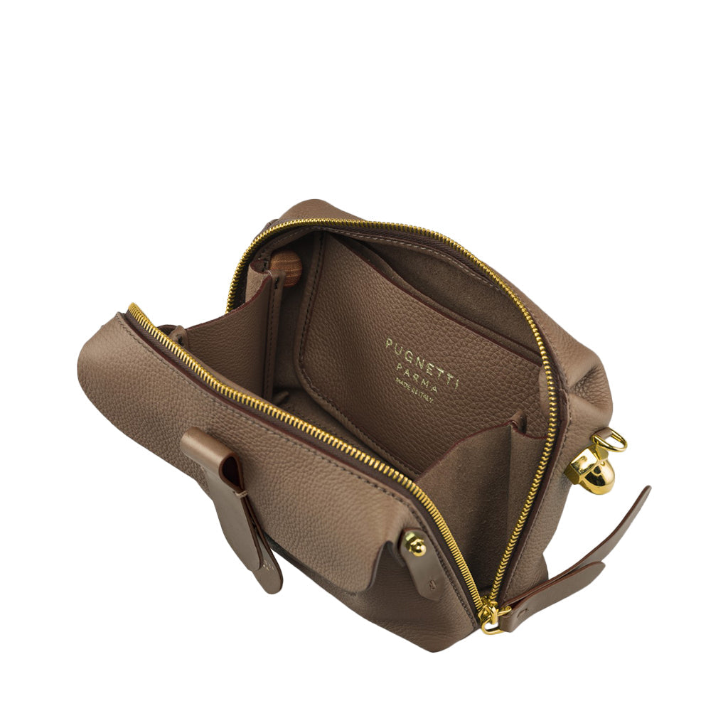 Open brown leather handbag with gold zippers and compartments