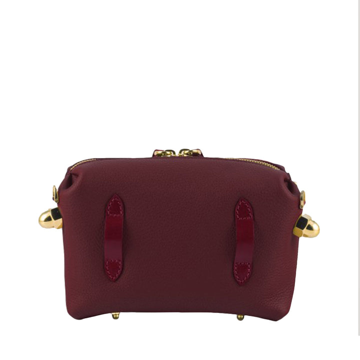 Maroon leather handbag with gold accents and top zipper closure