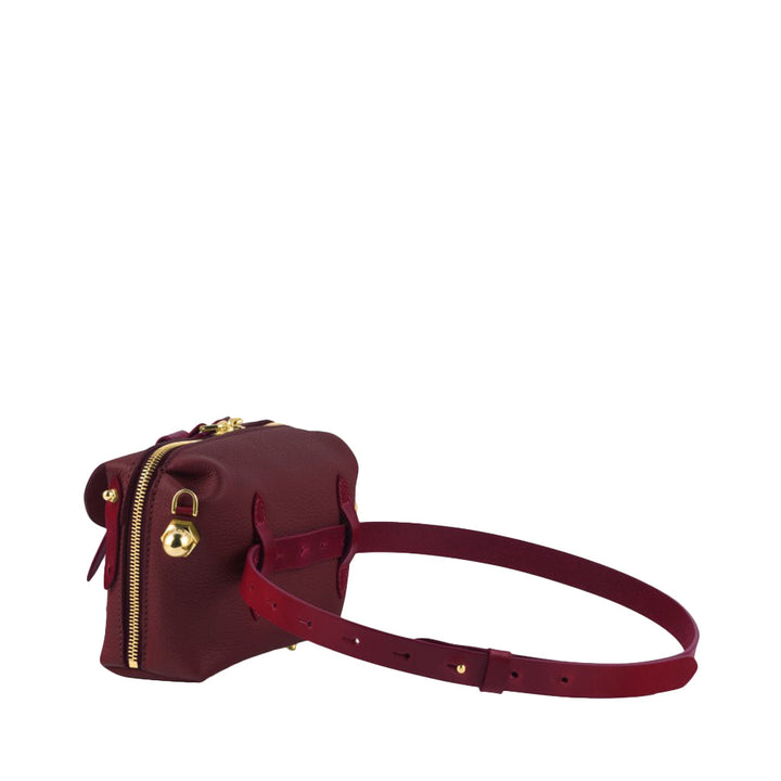 Burgundy leather crossbody bag with gold zipper and adjustable strap