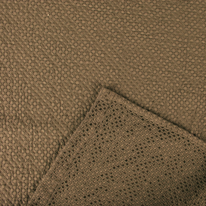 Close-up of textured brown fabric with dual patterns