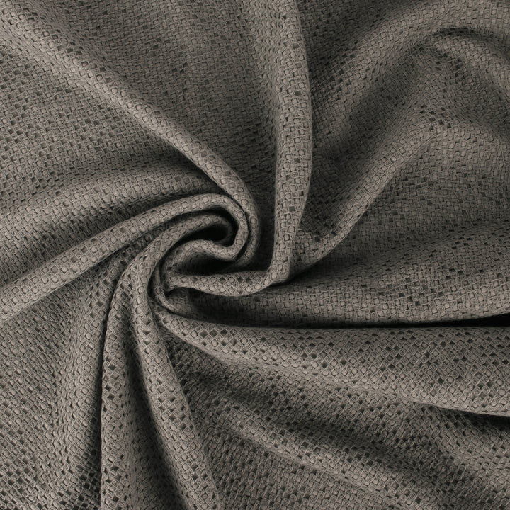 Close-up of textured gray fabric with a waffle weave pattern, draped and twisted