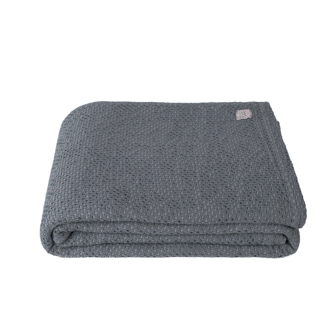 Grey folded knit blanket on white background