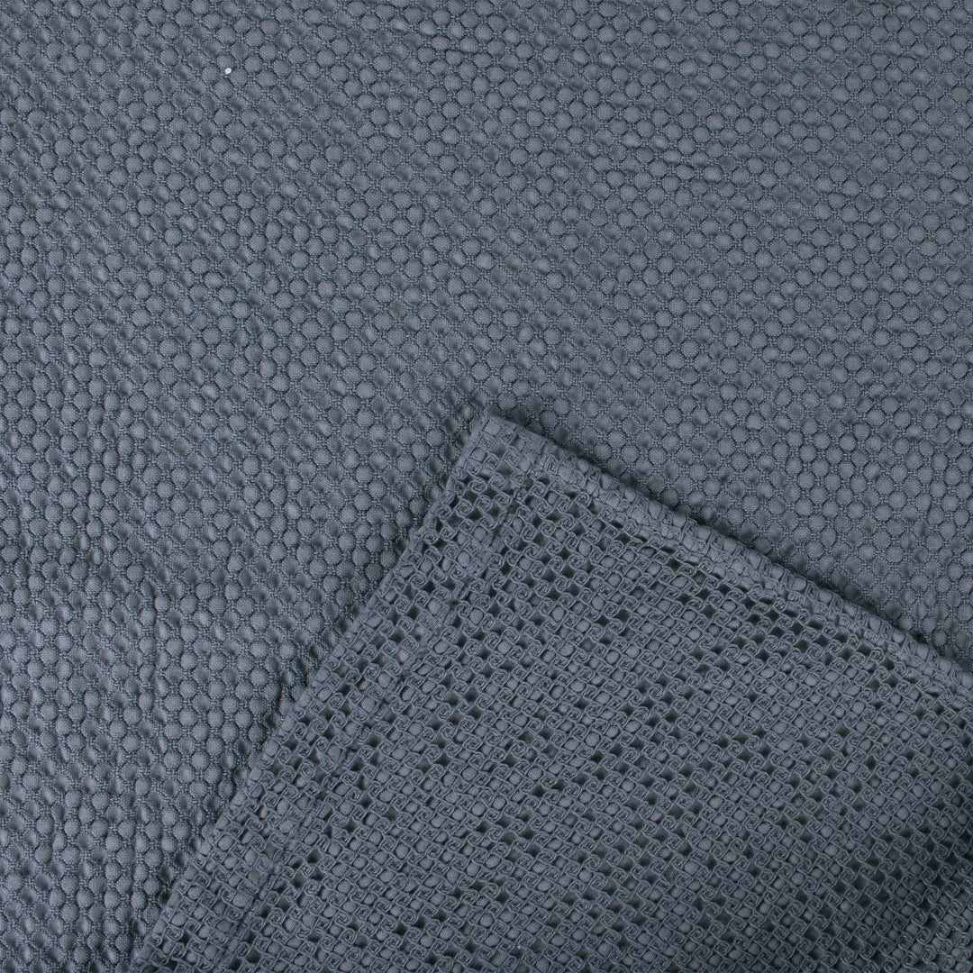 Close-up of a textured dark grey fabric with different woven patterns