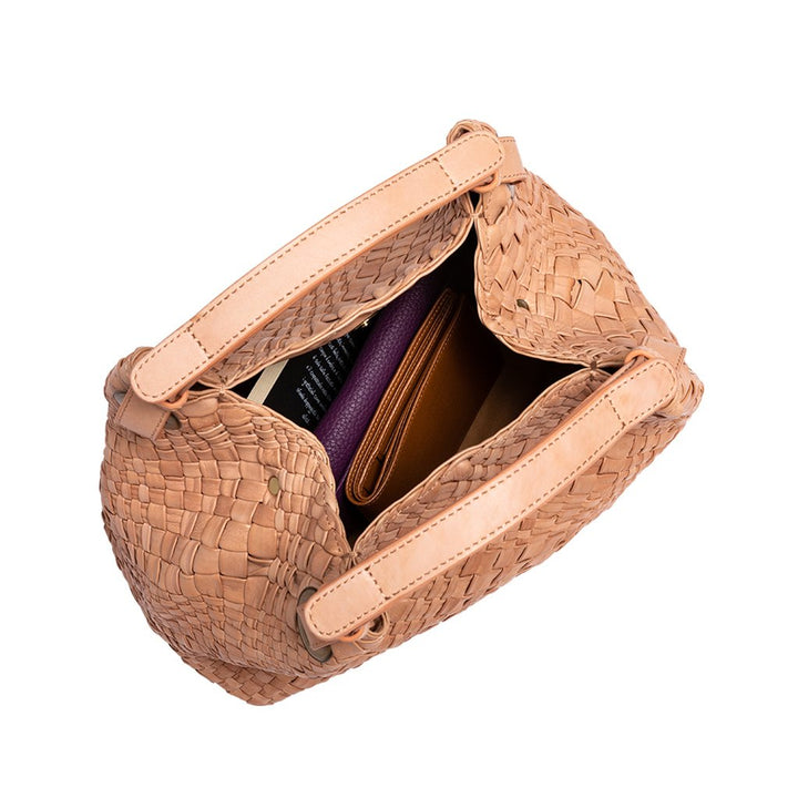 Tan woven handbag with contents visible, including a purple wallet