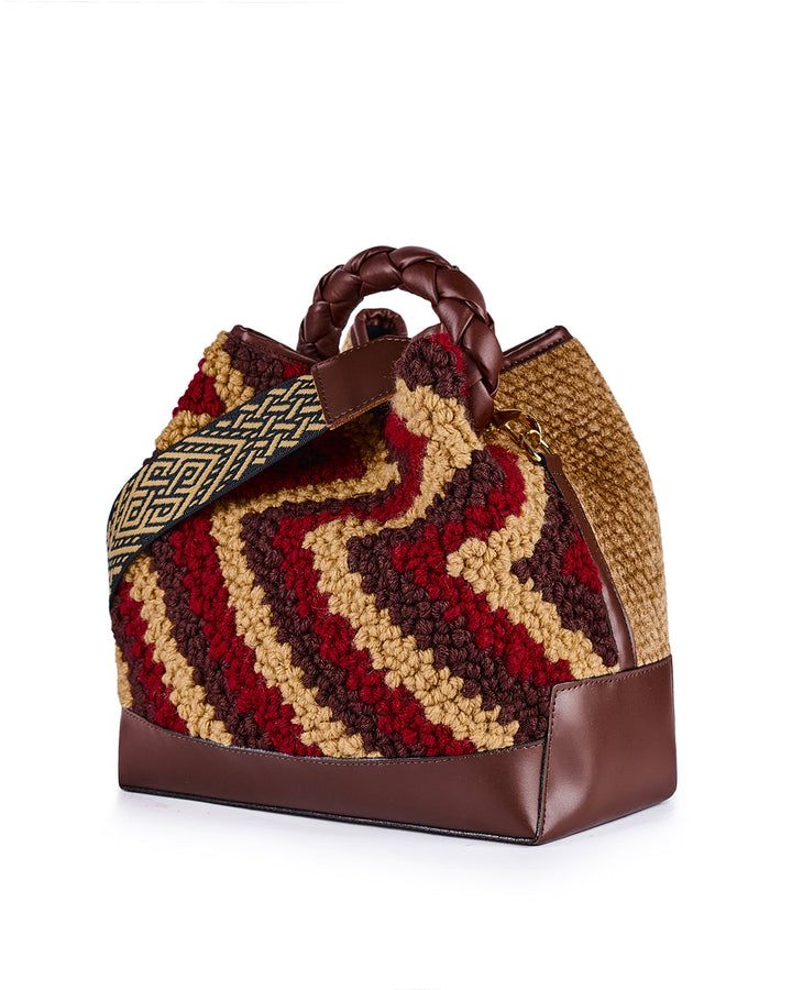 Handcrafted multicolored woven bag with leather accents and patterned strap