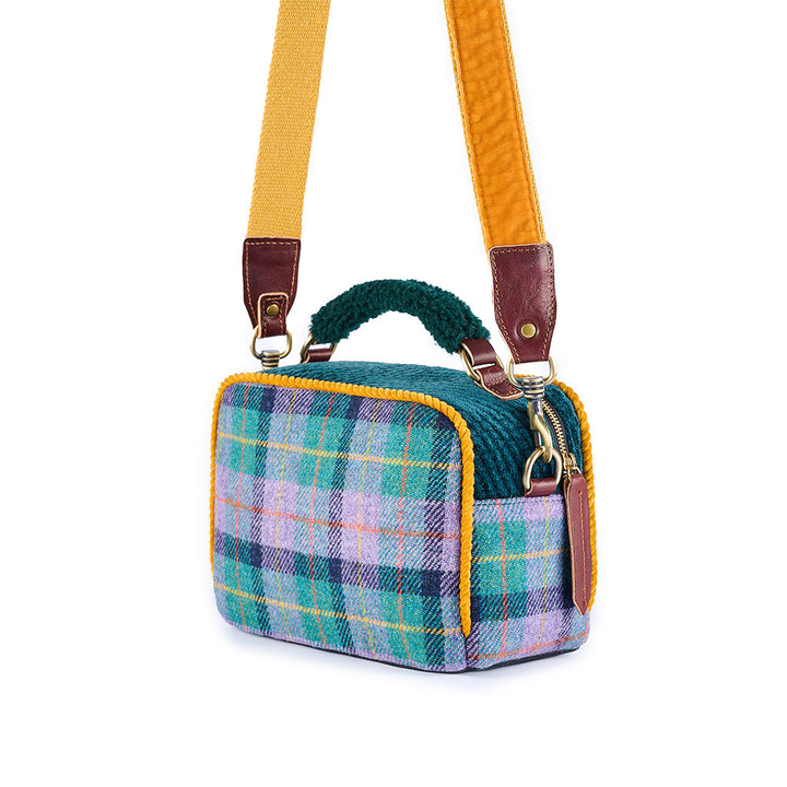 Patterned fabric shoulder bag with yellow strap and leather details