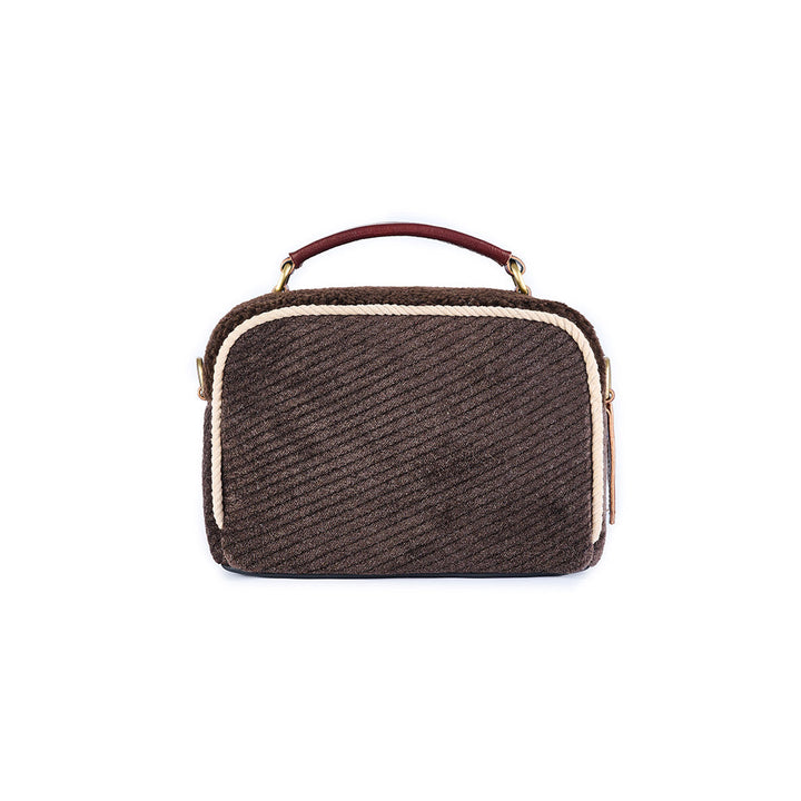 Brown textured handbag with white trim and a maroon handle on a white background