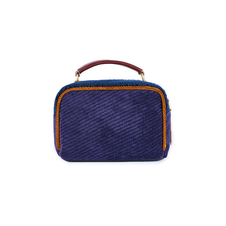 Small navy blue textured handbag with brown and gold accents