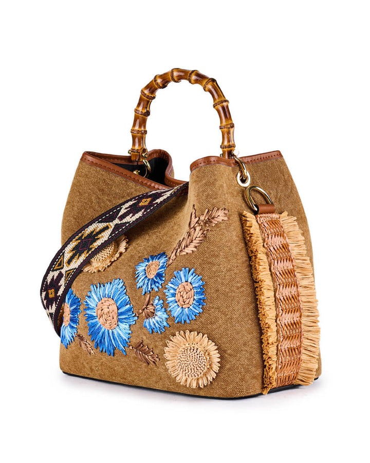 Boho-chic handbag with blue floral embroidery and a bamboo handle