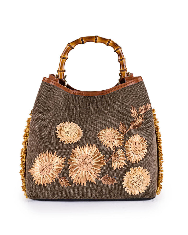 Designer handbag with floral embroidery and bamboo handles