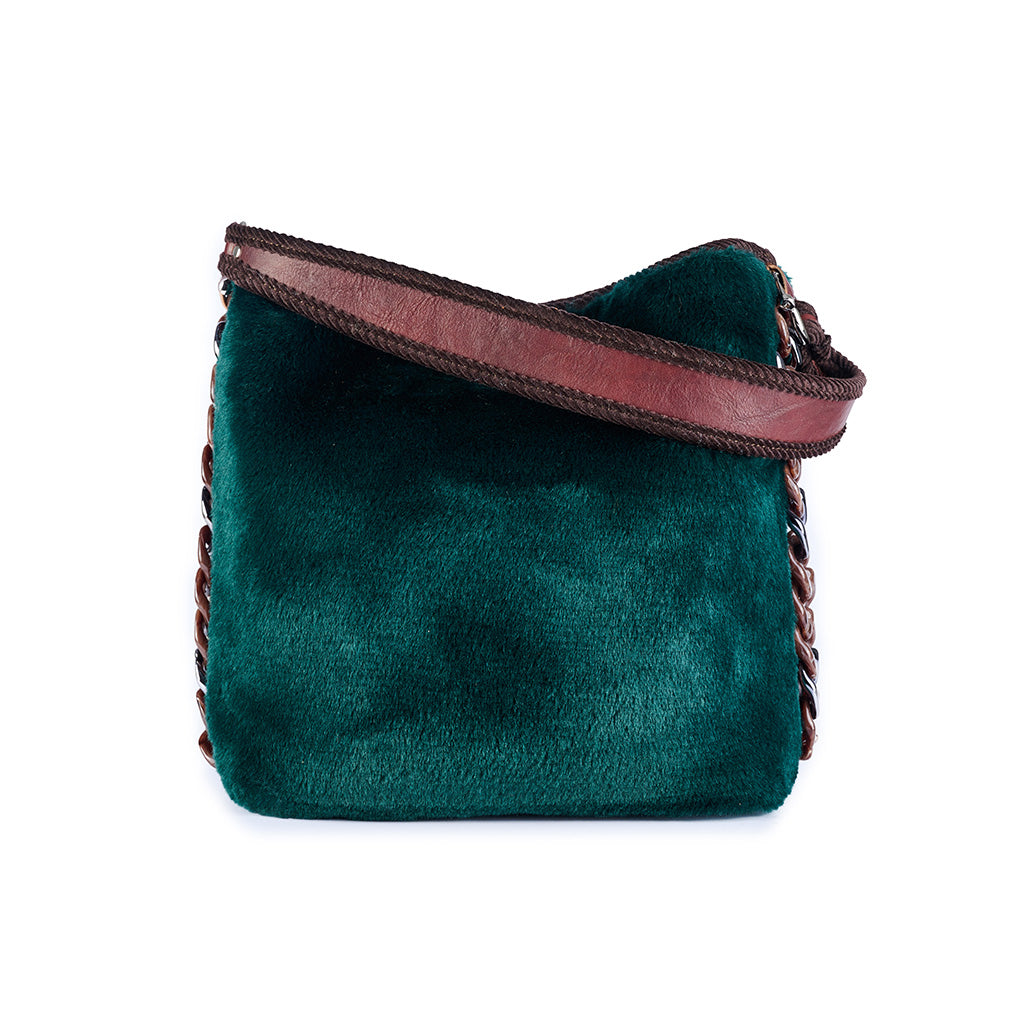 Luxurious green velvet handbag with brown leather strap and chain detailing