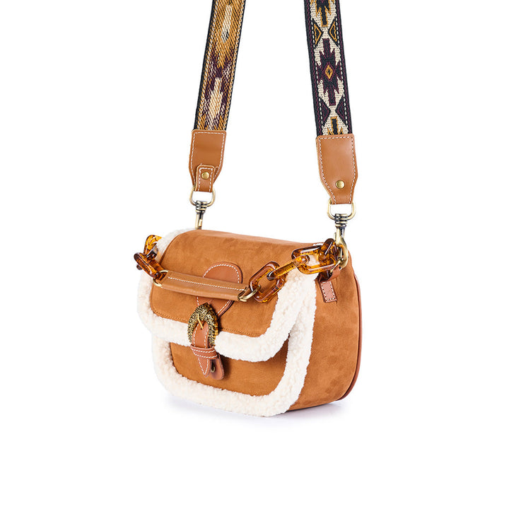 Brown leather crossbody bag with patterned strap and faux fur trim