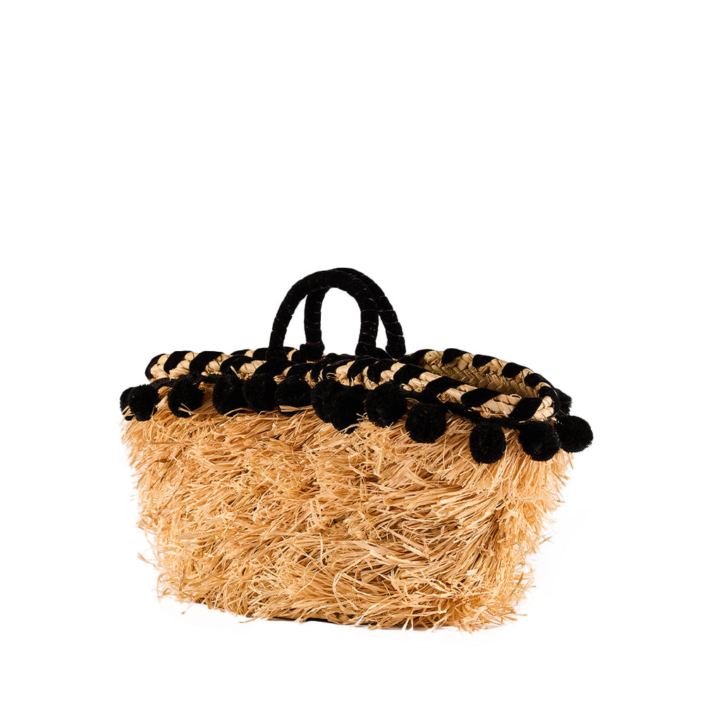 Straw handbag with black pom-pom trim and handles