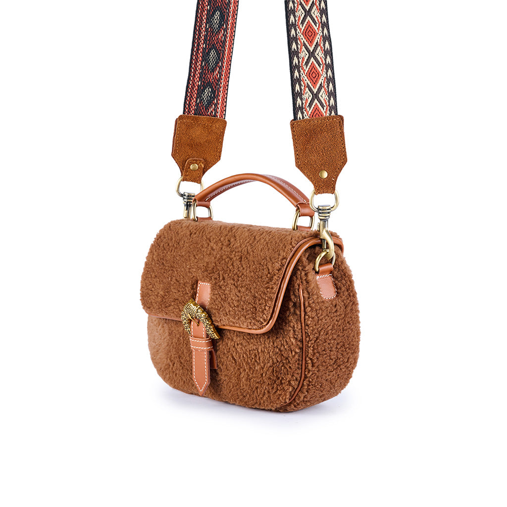 Brown faux fur crossbody bag with decorative adjustable strap and leather details