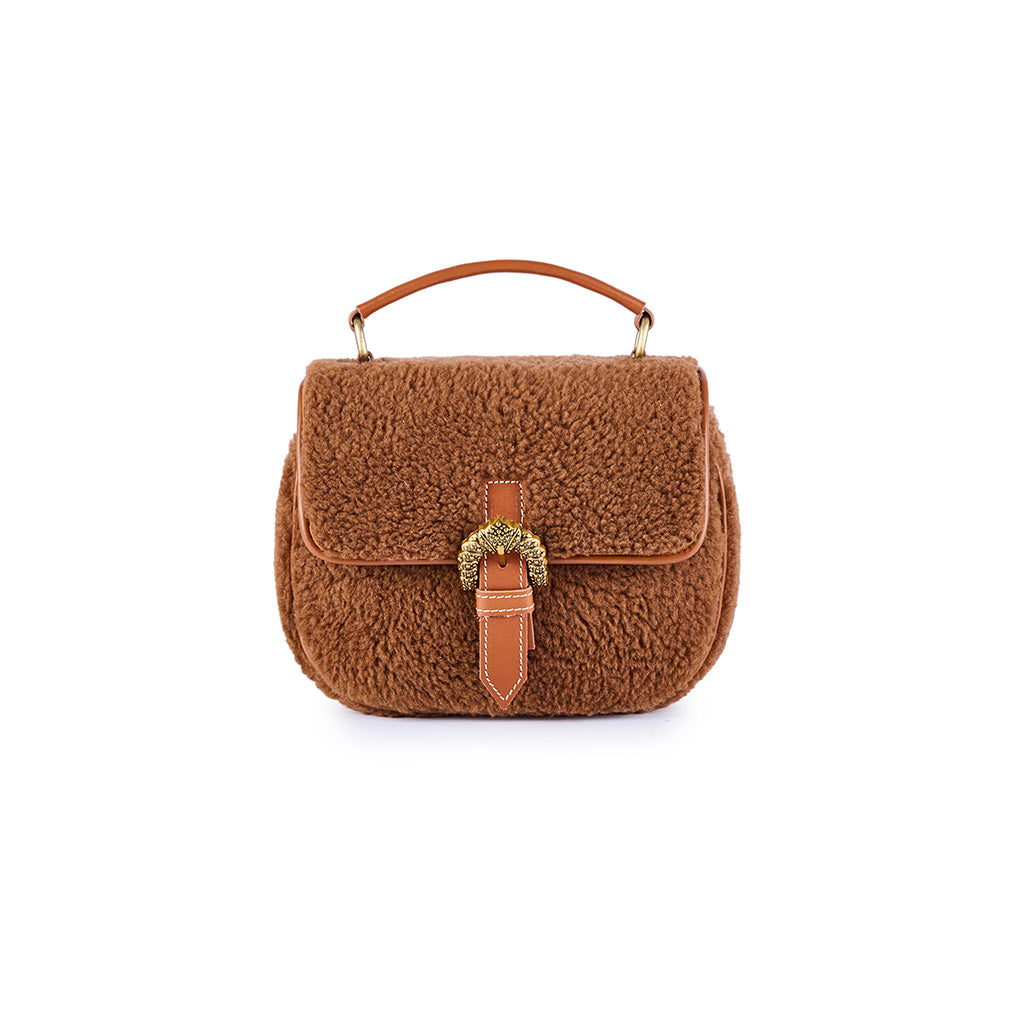 Brown shearling handbag with top handle and decorative buckle