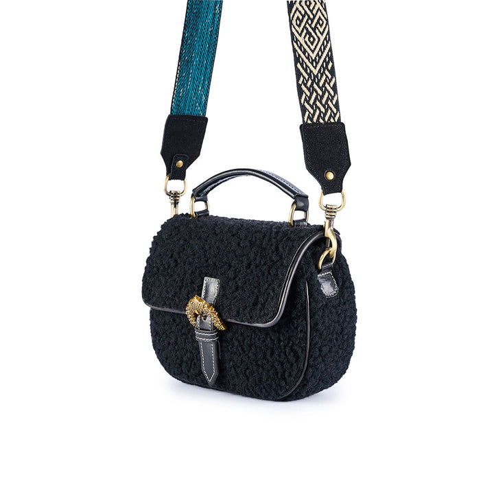 Black wool-textured handbag with patterned adjustable strap and gold buckle