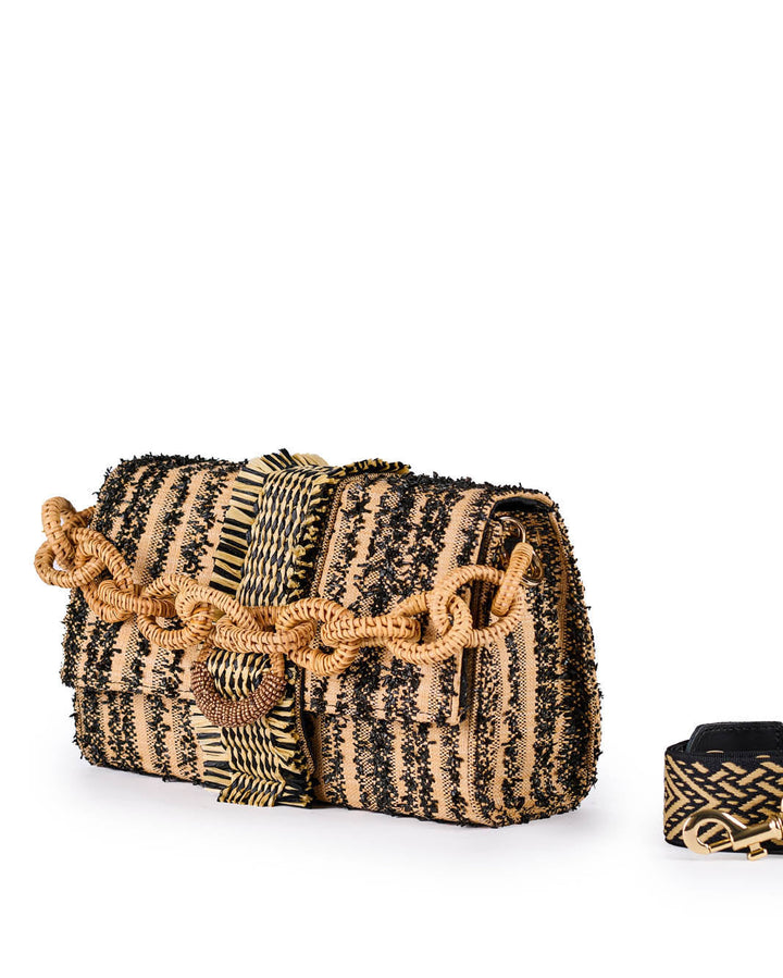 Stylish woven handbag with black and beige pattern and decorative chain strap