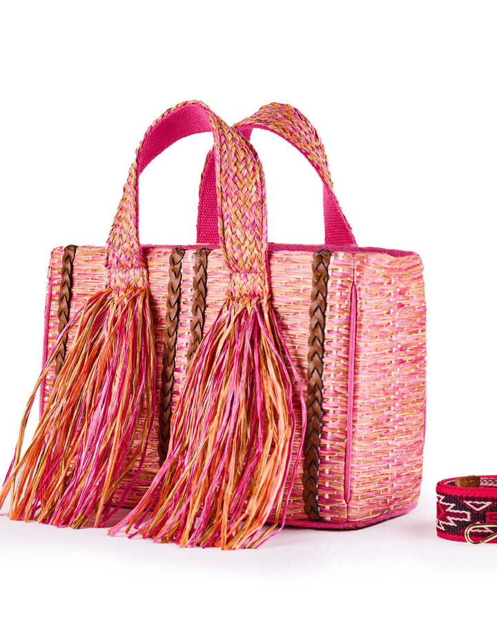 Pink woven straw bag with fringe tassels and a removable strap