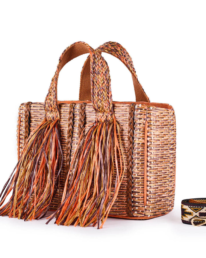 Handwoven straw tote bag with colorful tassels and woven shoulder strap