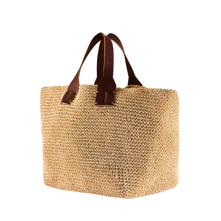 Handwoven straw tote bag with brown leather handles