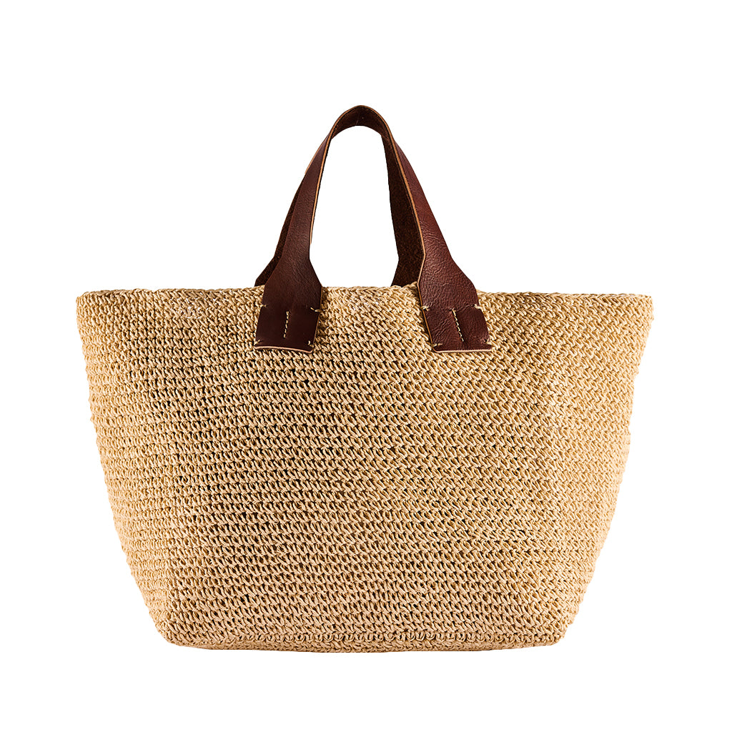 Woven straw tote bag with brown leather handles