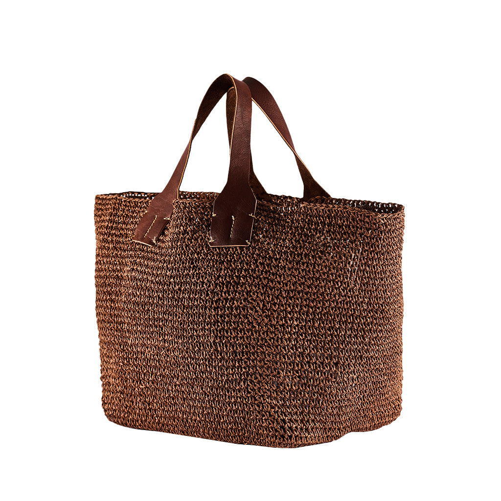 Handwoven brown straw tote bag with leather handles