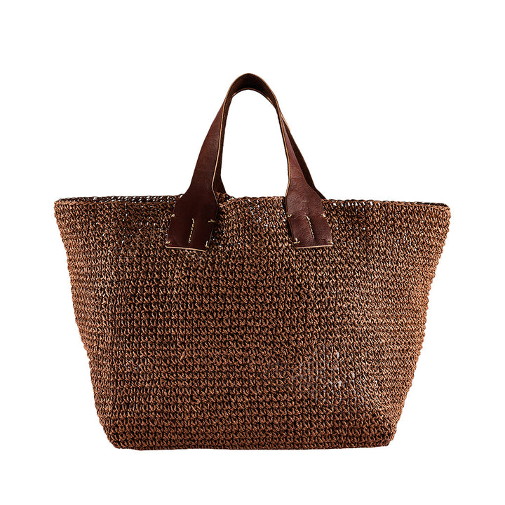 Brown woven tote bag with dark brown leather handles