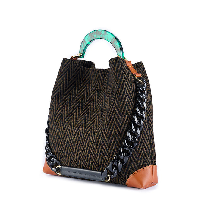 Black and brown herringbone handbag with turquoise handle and black chain strap