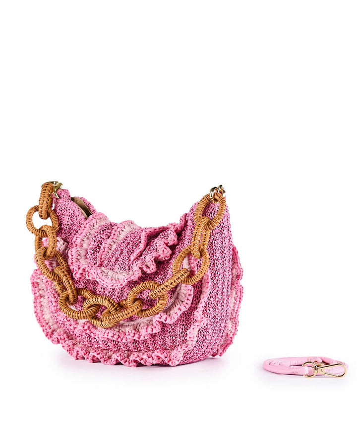 Pink knitted handbag with large chain links and matching keychain against white background