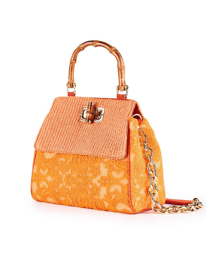 Orange textured handbag with bamboo handle and chain strap