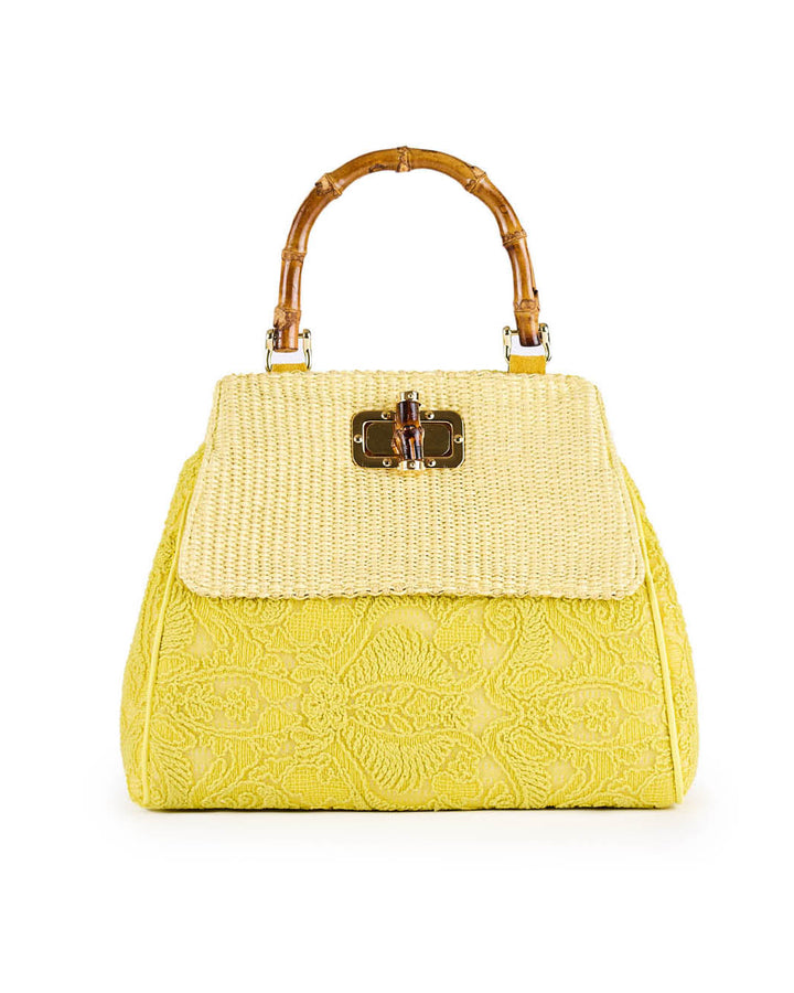 Yellow lace handbag with bamboo handle and gold clasp