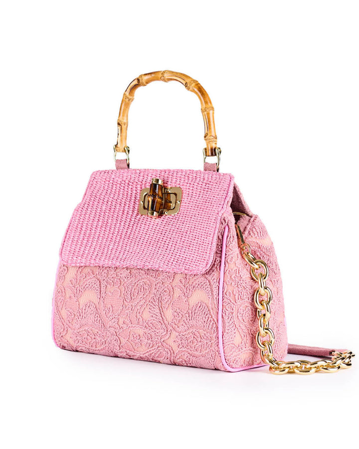 Pink textured handbag with bamboo handle and chain strap
