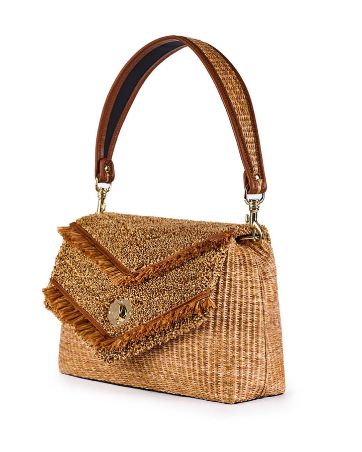 Stylish woven straw handbag with brown leather strap and fringed flap detailing