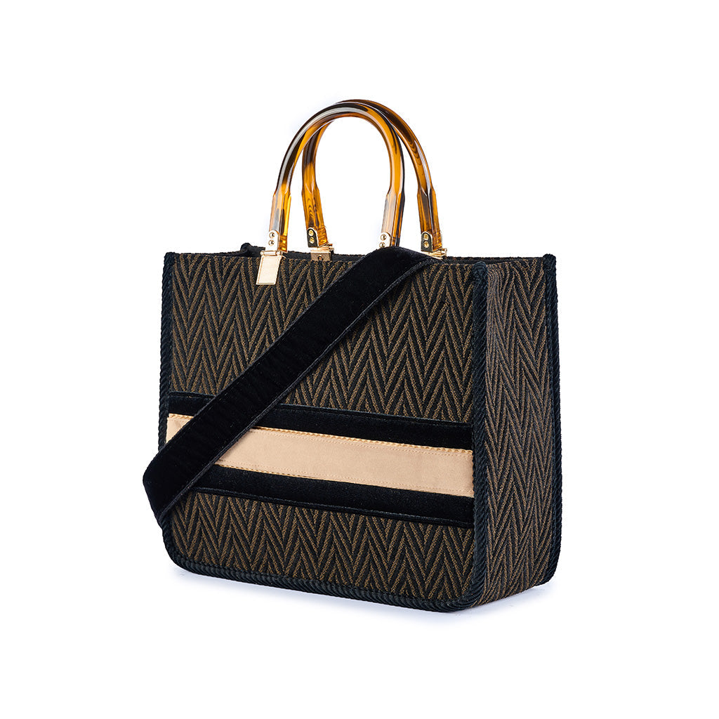 Luxury herringbone handbag with amber handles and black strap