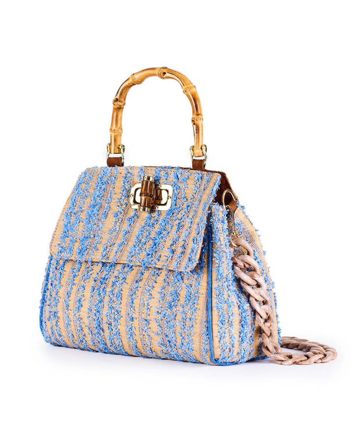 Elegant blue-textured handbag with bamboo handle and chain strap