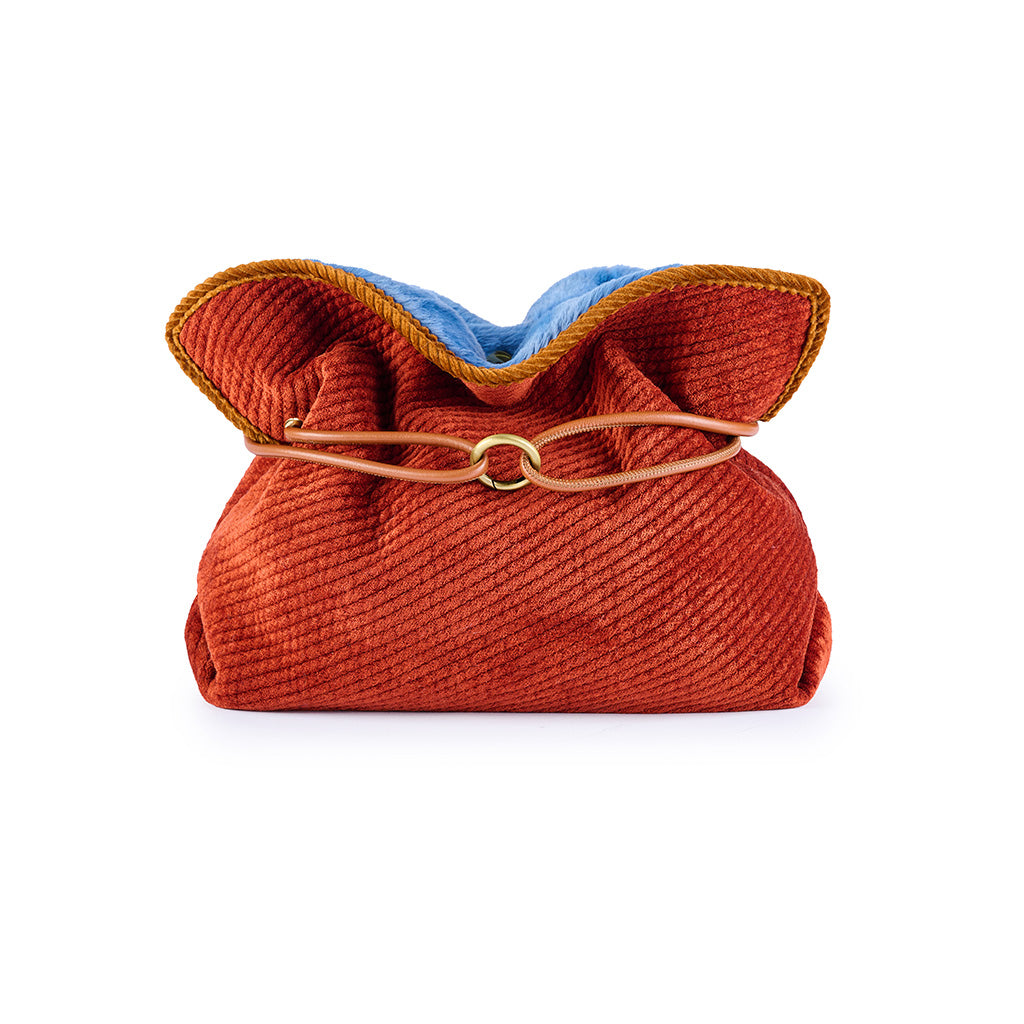 Colorful, textured fabric handbag with a gold clasp and ruffled top