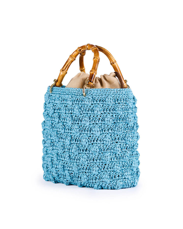 Blue crocheted handbag with bamboo handles and beige fabric lining