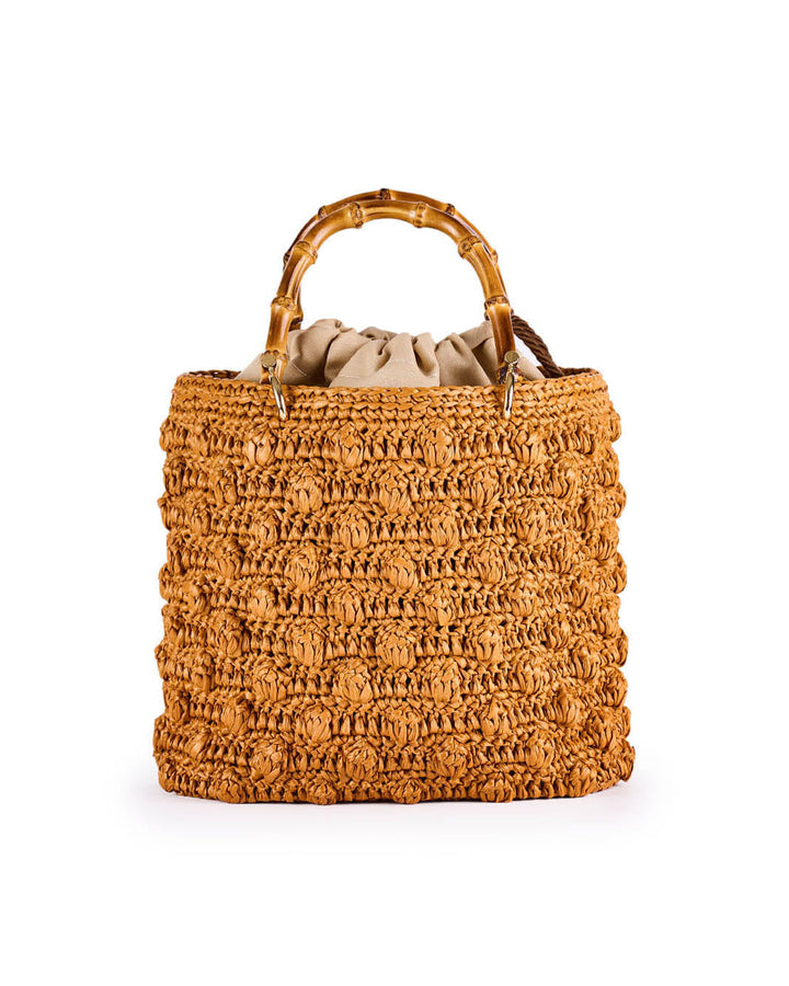 Handwoven straw handbag with bamboo handles and drawstring closure