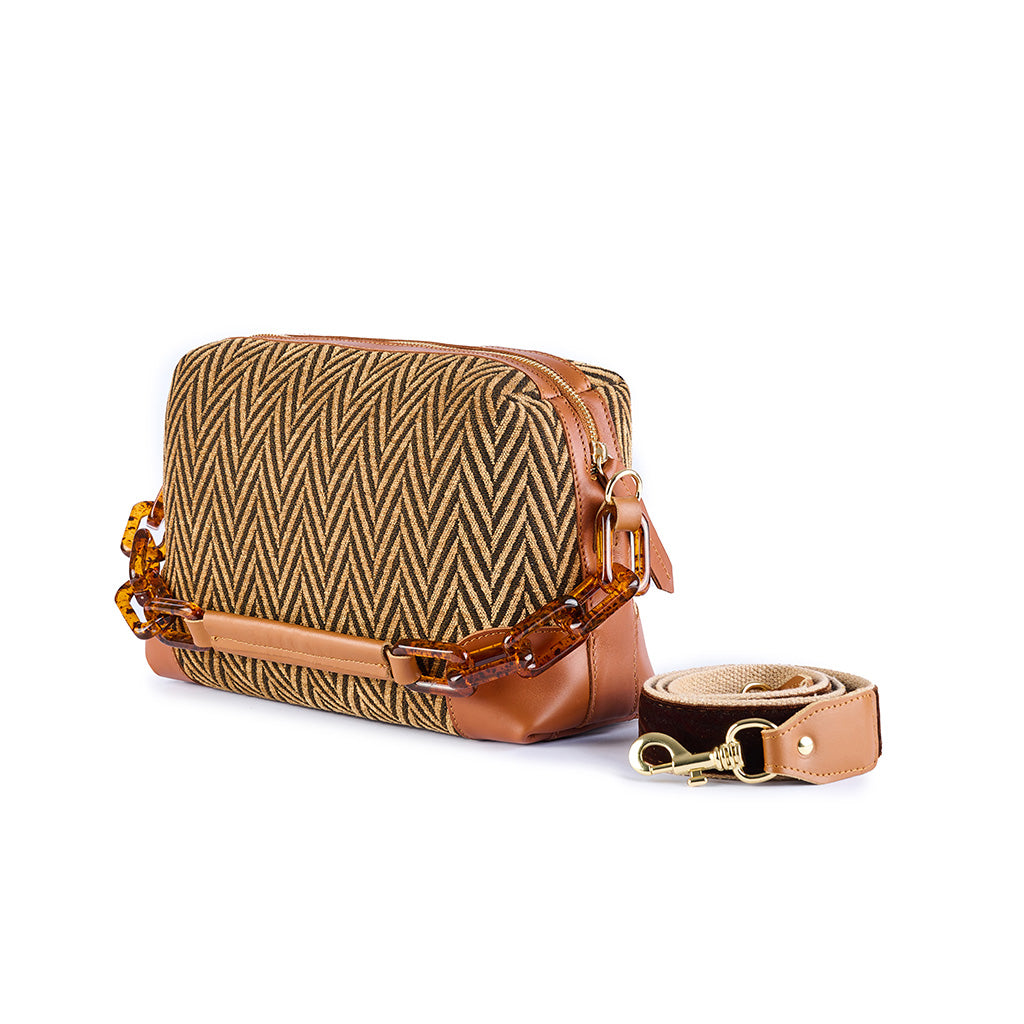 Brown leather handbag with a woven zigzag pattern and detachable strap