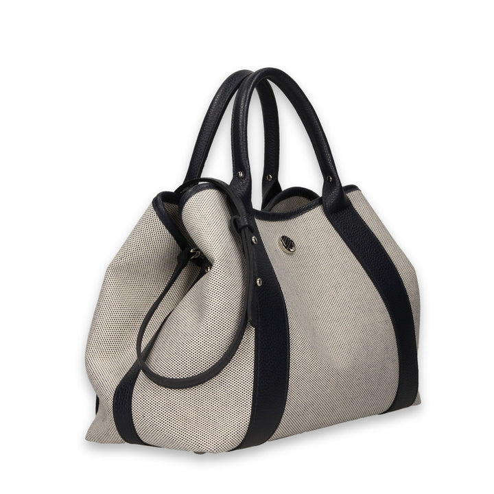 Elegant textured handbag with black leather handles and trim