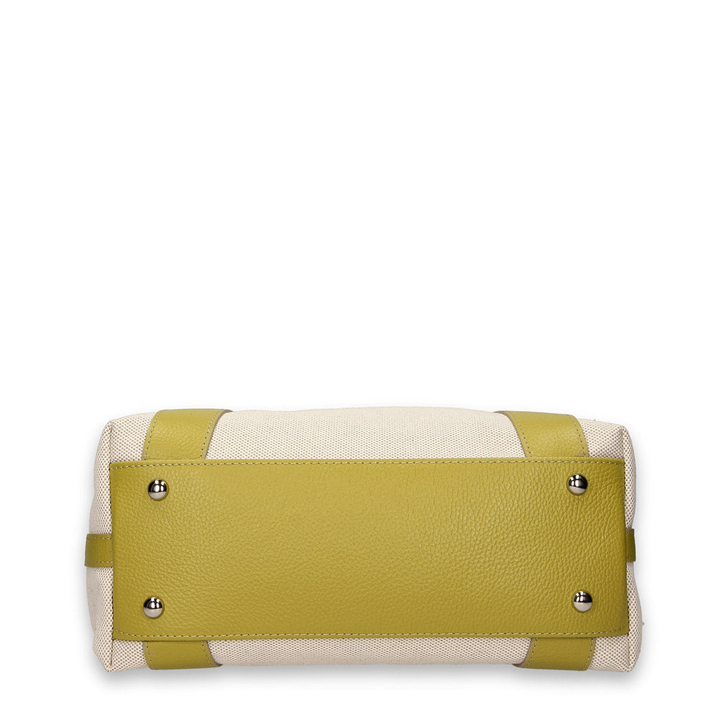 bottom view of a designer handbag with white body and green leather base featuring metal studs