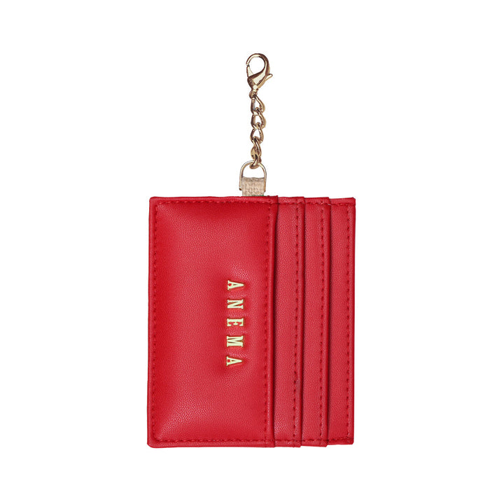 Red leather card holder with gold chain and ANEMA branding